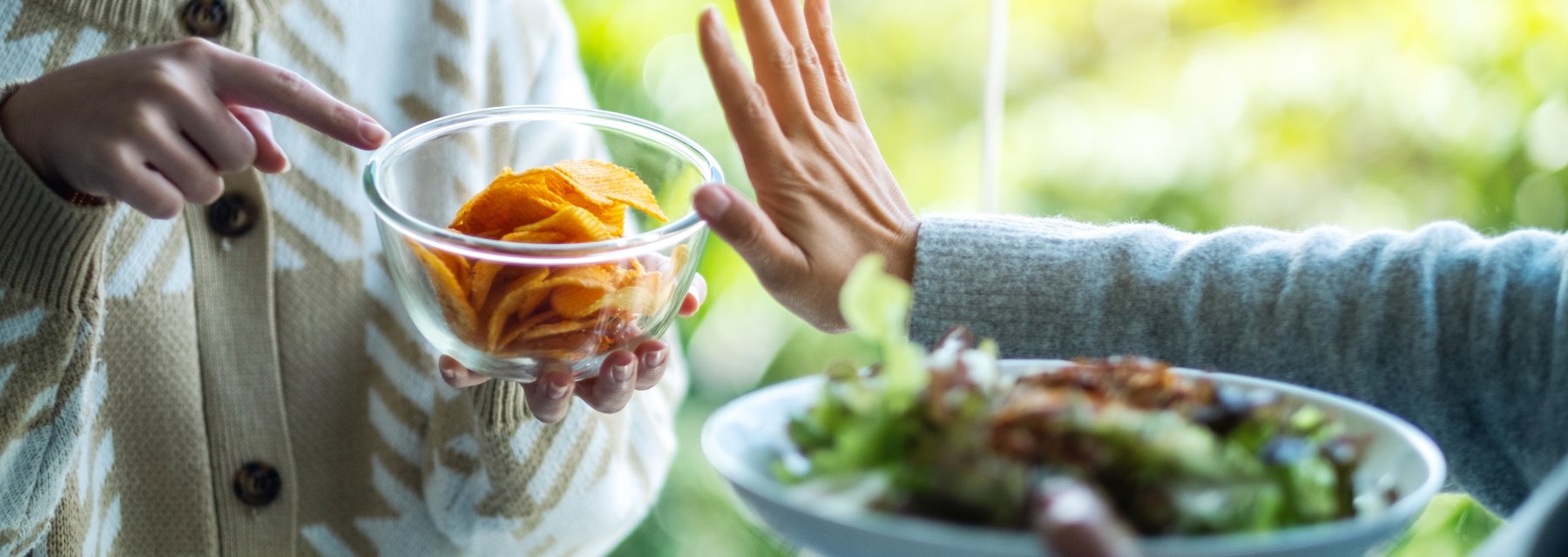 Woman Extends Her Hand Towards a Bowl of Fresh Salad at Meadville Pennsylvania