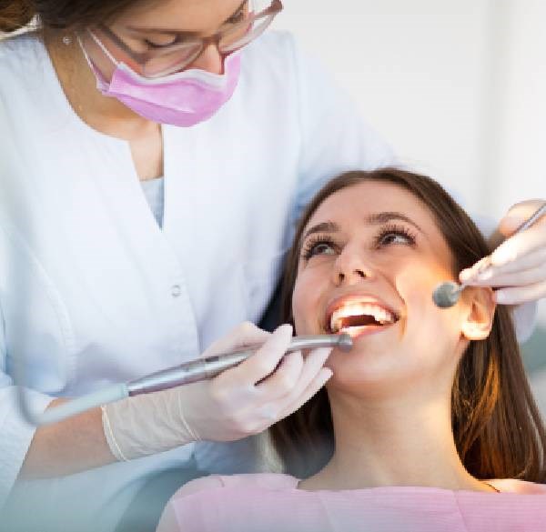 Dentist In Gloves Holding Instruments Near Patient at Meadville Pennsylvania