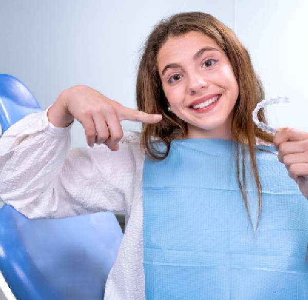 Girl Is Holding a Dental Device at Meadville Pennsylvania