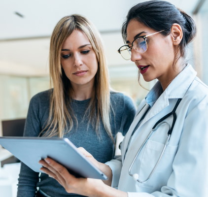 Two Women In Medical Attire Analyzing Data On A Tablet At Meadville Pennsylvania